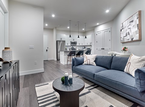 A modern living room with a grey sofa and a coffee table.