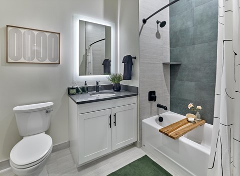 A white toilet sits next to a sink in a modern bathroom.