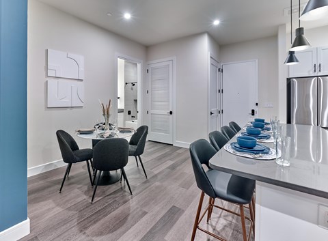 A modern dining room with a table set for six.