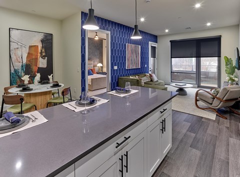 Residences A modern kitchen with a dining table and chairs.
