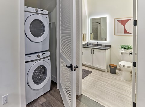 A white washer and dryer in a small laundry room.