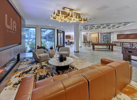 A modern living room with a brown leather sofa and a coffee table.
