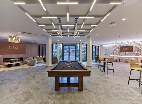 A billiard table and game table in a private resident clubroom
