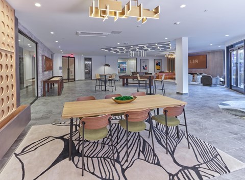 A modern Club room with a large table and chairs.