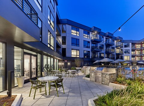 A modern building with a pool and a patio area.