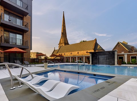 a swimming pool with a church in the background