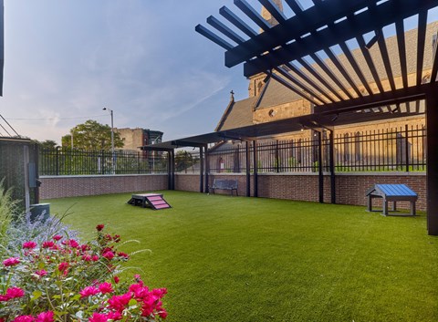 a backyard with a lawn and a picnic table and a pergola