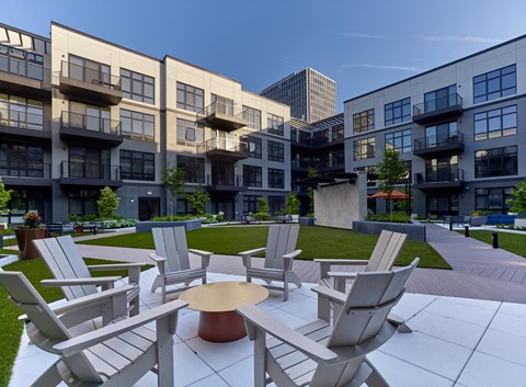 a communal area with chairs and tables on a lawn