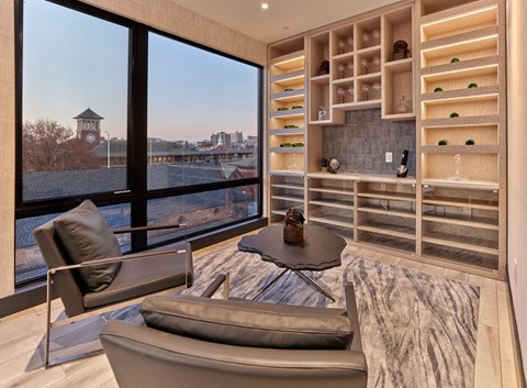 Resident amenities with bar area, clubroom, game tables, lounge seating, and private meeting room at Vermella Broad Street, Newark NJ