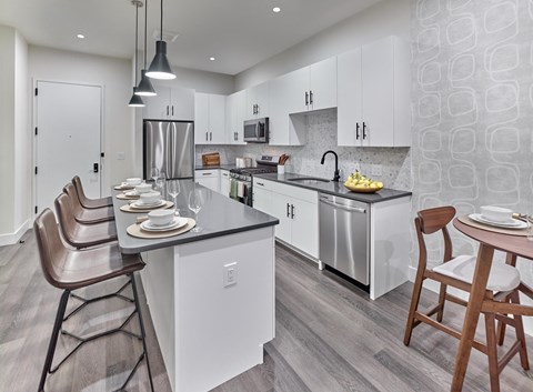 large chef-inspired kitchen, stainless-steel appliances, open layout, large windows