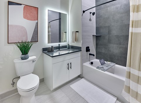 Luxury bathroom with tiled shower and backlit vanity at Vermella Broad Street, Newark NJ