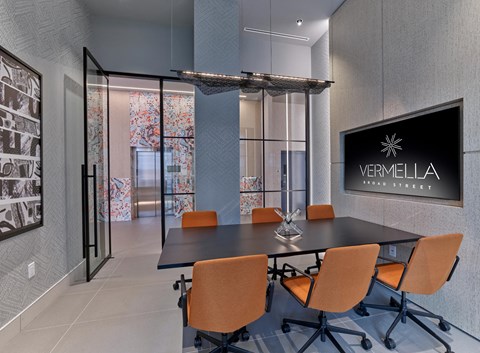 a conference room with a table and chairs