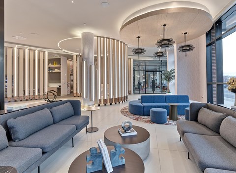 a rendering of a lobby with couches and tables