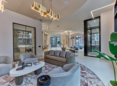 a lobby with couches and chairs and a table