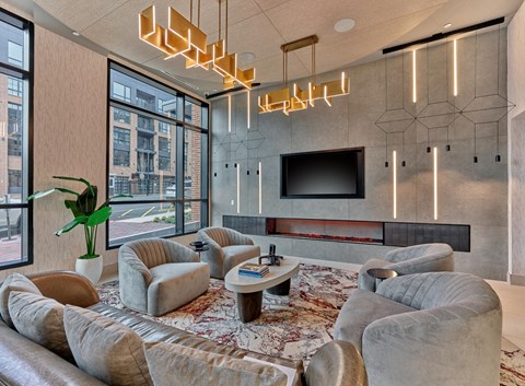 a living room with couches and chairs and a television