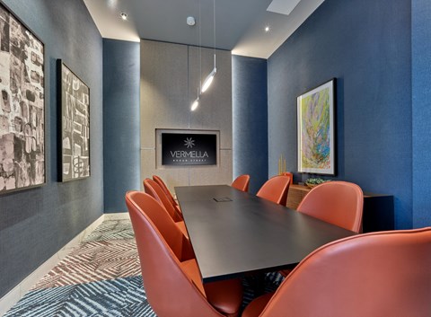 a conference room with a table and chairs and a fireplace