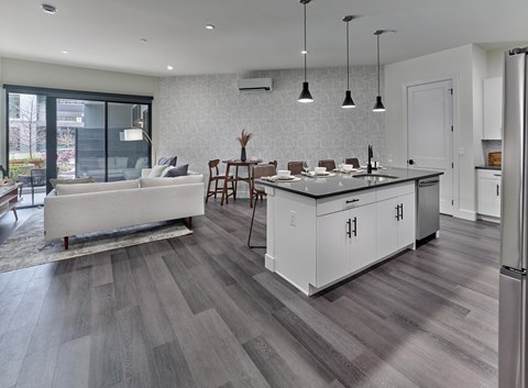 a kitchen and living room with a large island in the middle