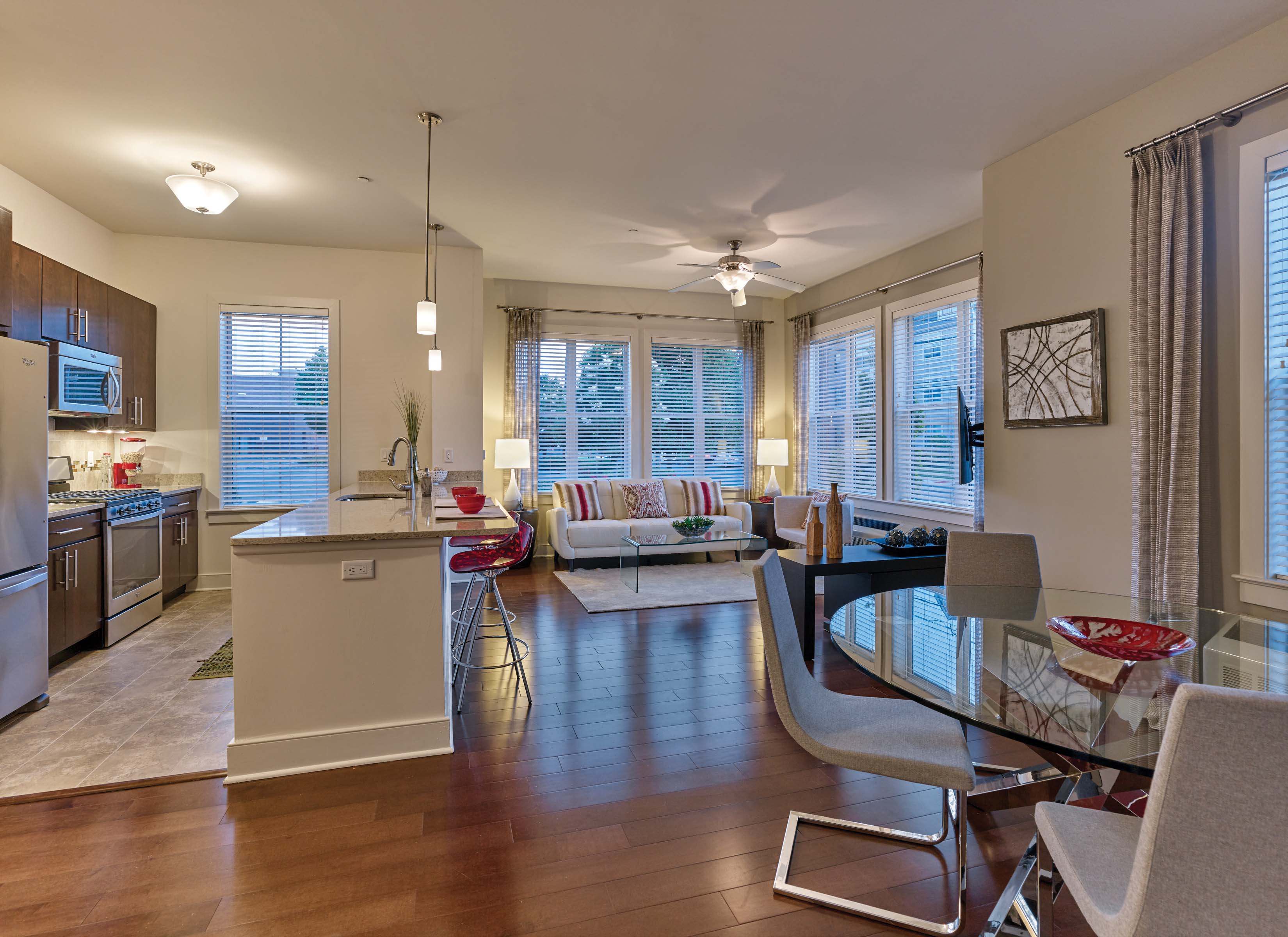 A modern kitchen with a dining table and chairs.