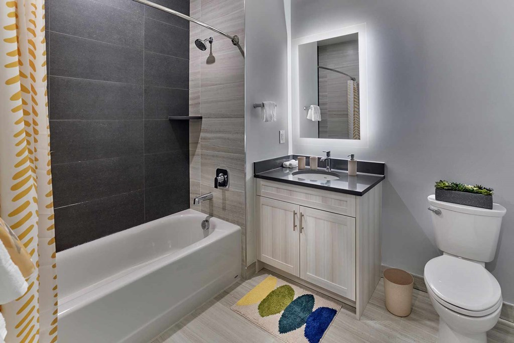 A bathroom with a white toilet, sink, and bathtub.