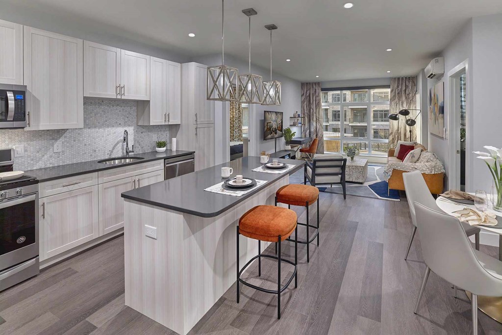 A modern kitchen with a bar area and a dining area.