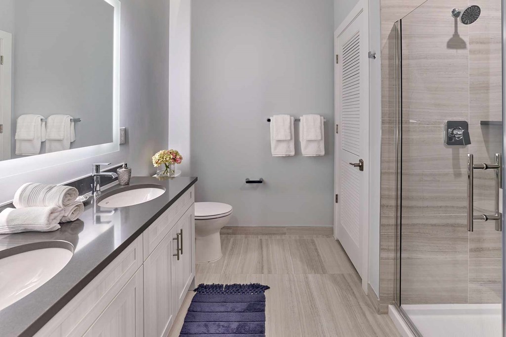 A bathroom with a sink, toilet, and shower.