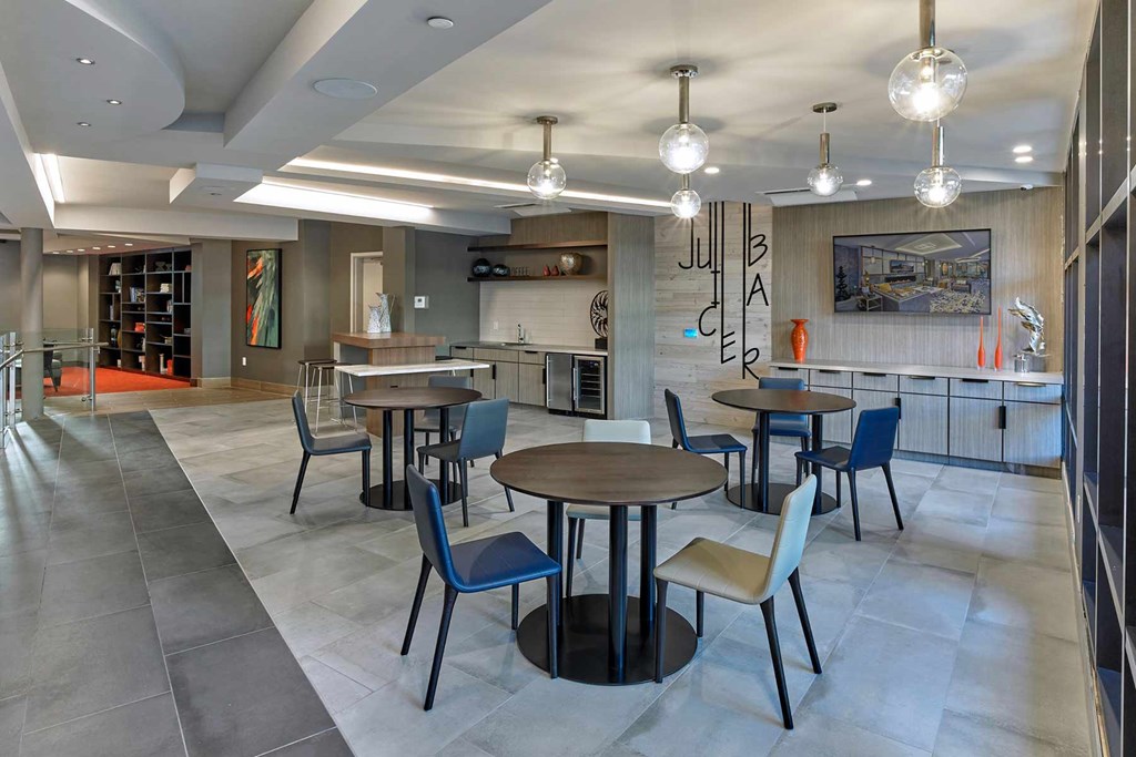 A modern dining area with a wooden table surrounded by chairs.