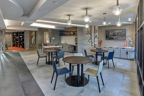 A modern dining area with a wooden table surrounded by chairs.