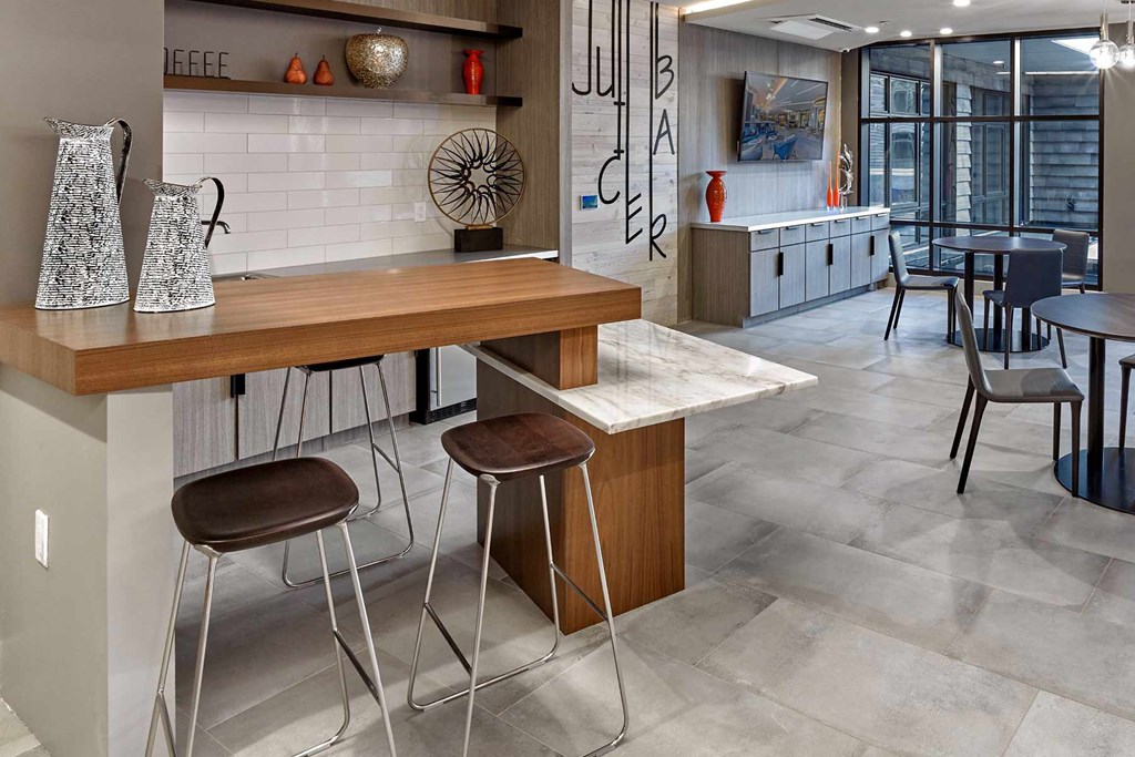 A kitchen with a bar area and a dining table.