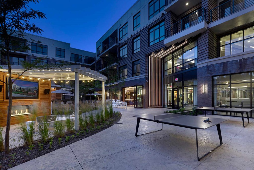 A modern building with a patio and a table.