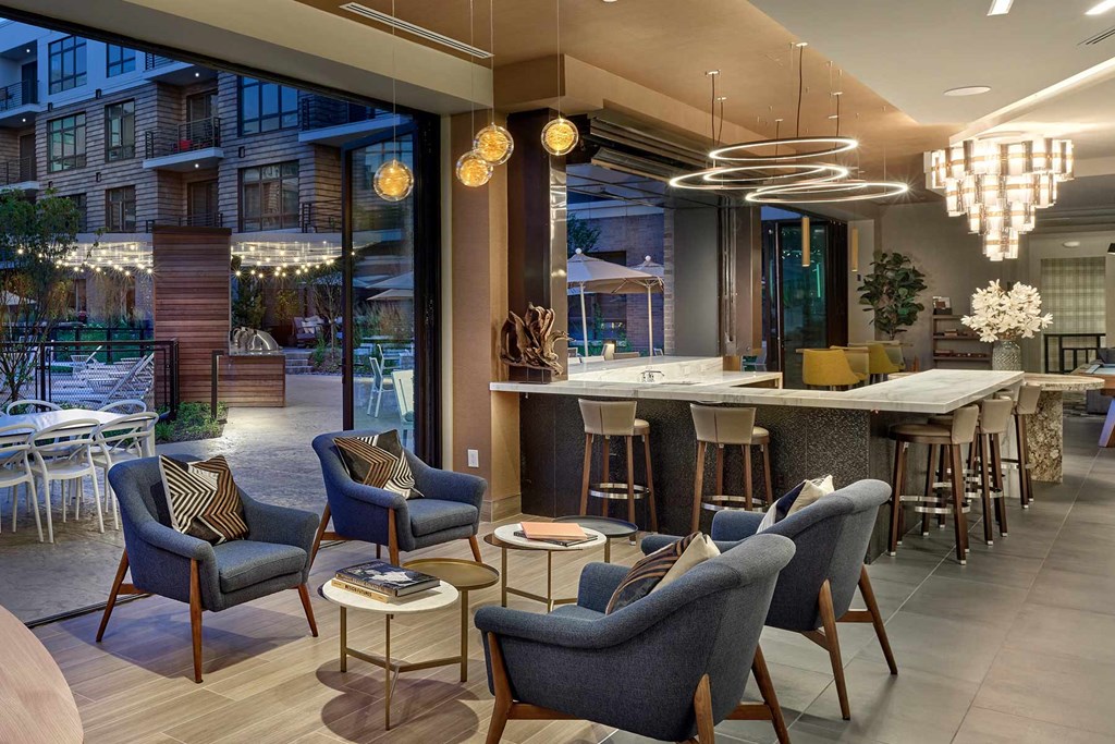 A modern living room with a bar area and comfortable seating.