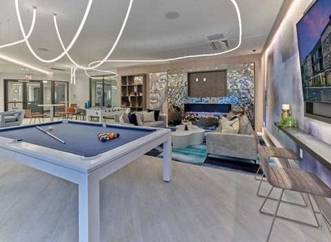 a pool table in a living room with a fireplace