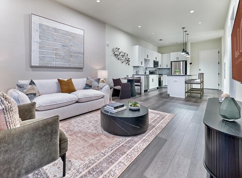 A modern living room with a grey sofa and a coffee table.