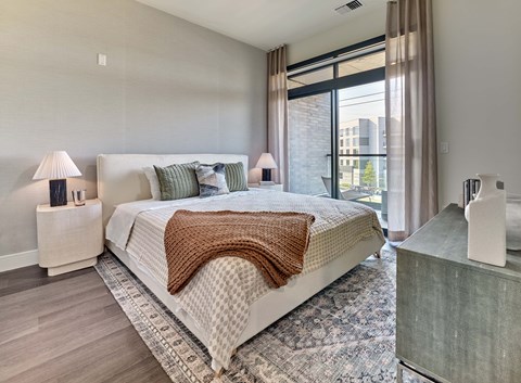 A bedroom with a large bed and a window.