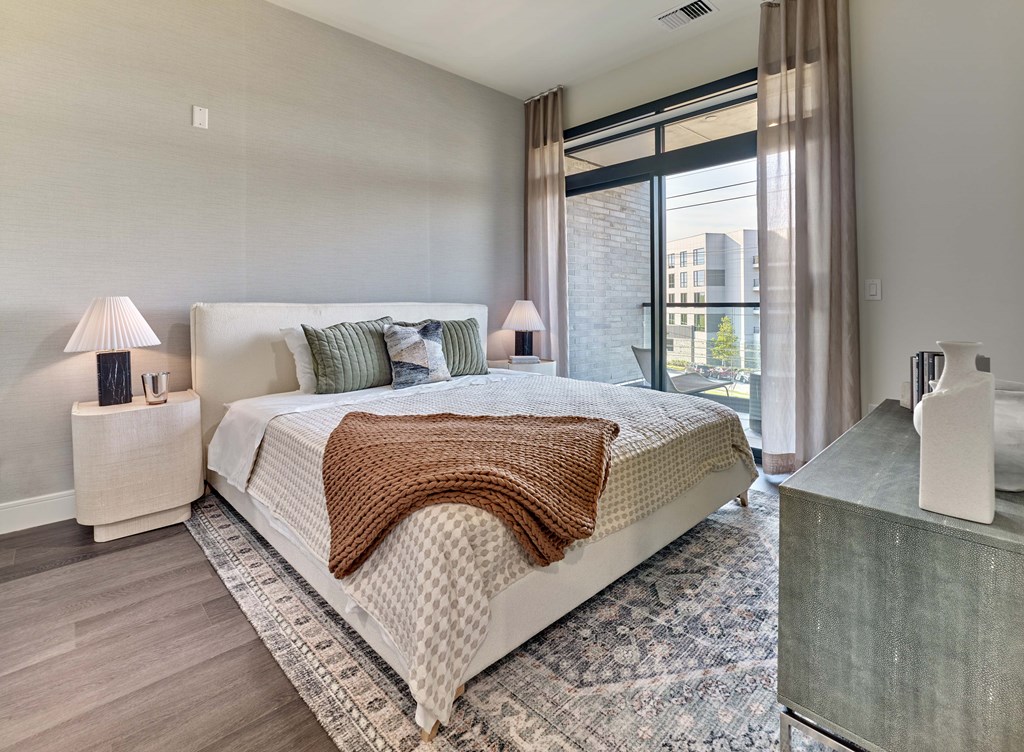 Residences A bedroom with a large bed and a window.