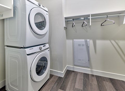 A white washing machine and dryer in a laundry room.