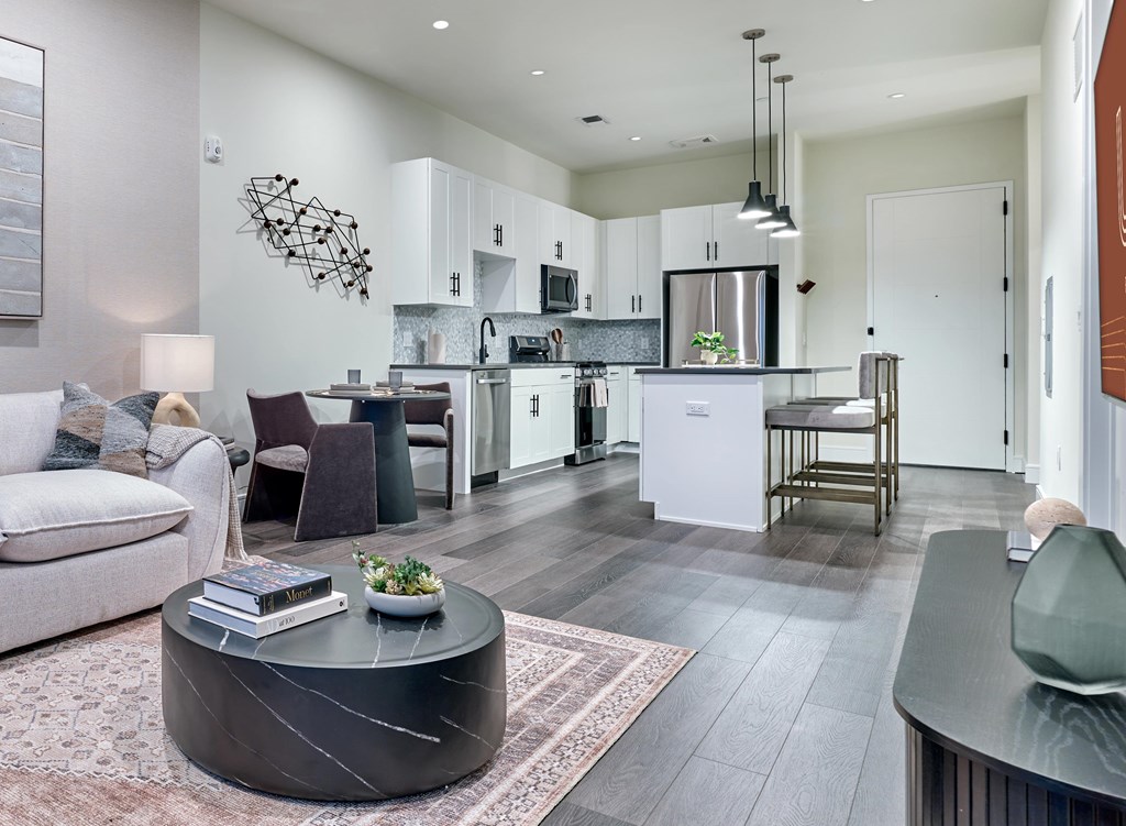 Residences A modern kitchen with a dining table and chairs.