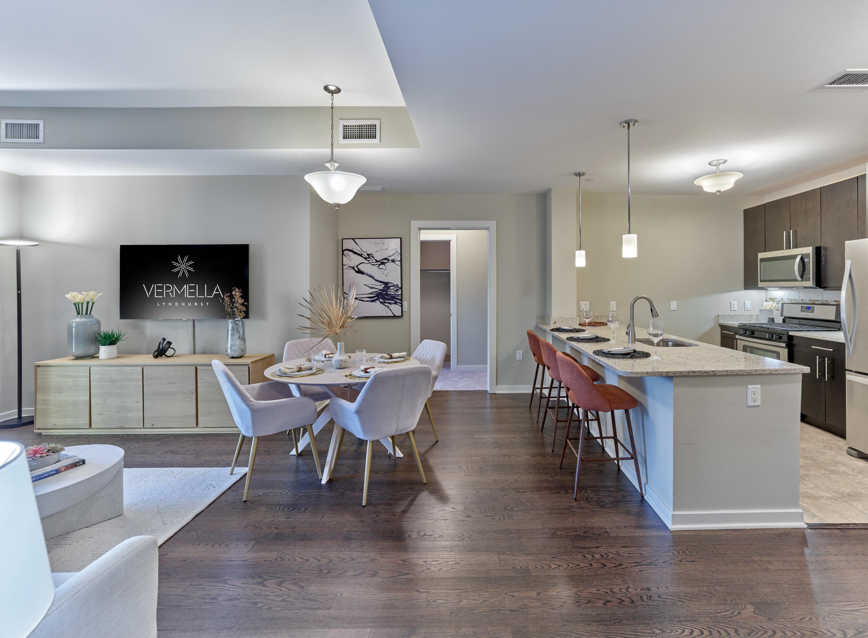 A kitchen with a dining table and chairs in the middle of the room.