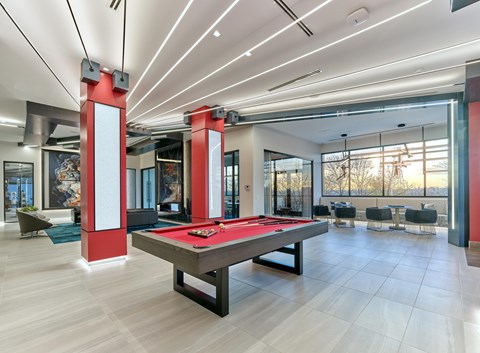 A billiard table in a room with a red and white color scheme.