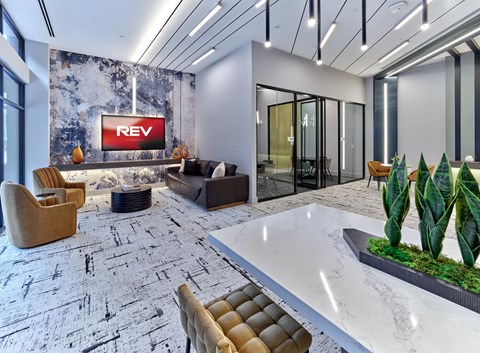 A modern office space with a large REV sign on the wall.
