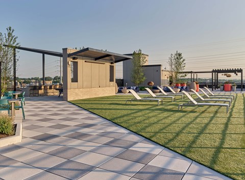 A sunny day at the park with a checkerboard patterned walkway.