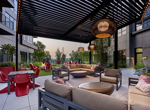 A patio with a variety of seating options including couches, chairs, and tables.