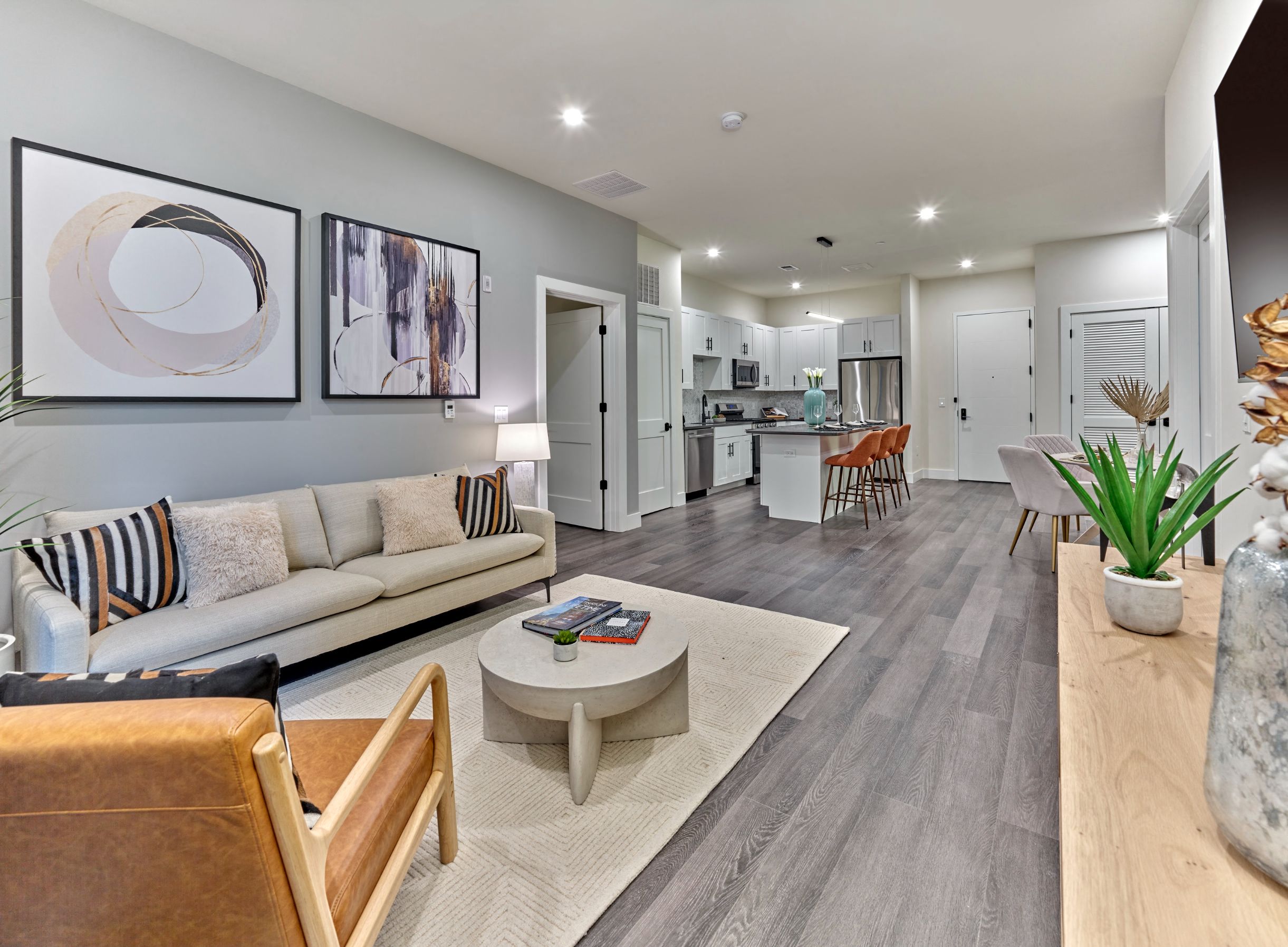 A modern living room with a white sofa and a coffee table.