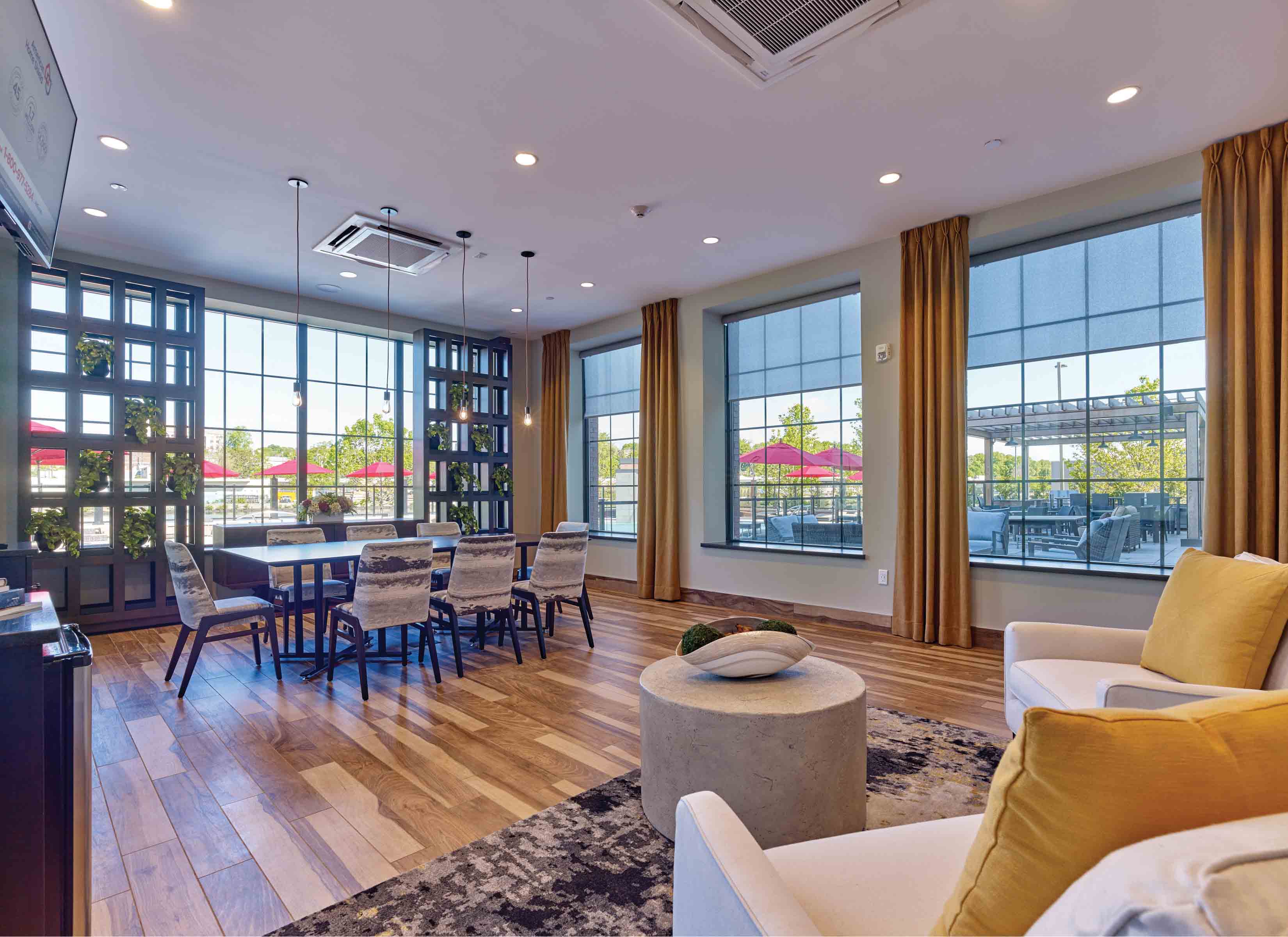A spacious living room with a dining table and chairs.