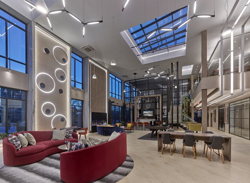 Amenities Clubroom with modern lighting and skylights