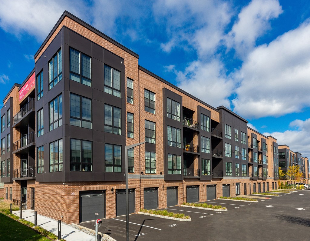 a large brick apartment building with a blue sky in the background