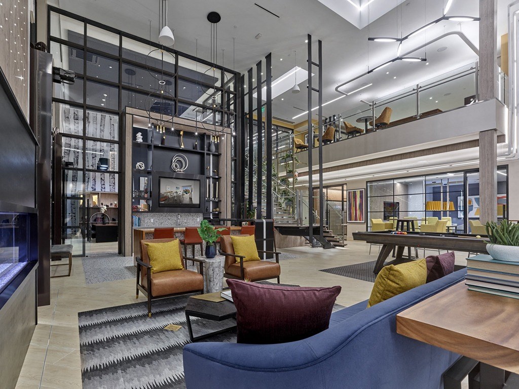 a lobby with couches and chairs and a fireplace