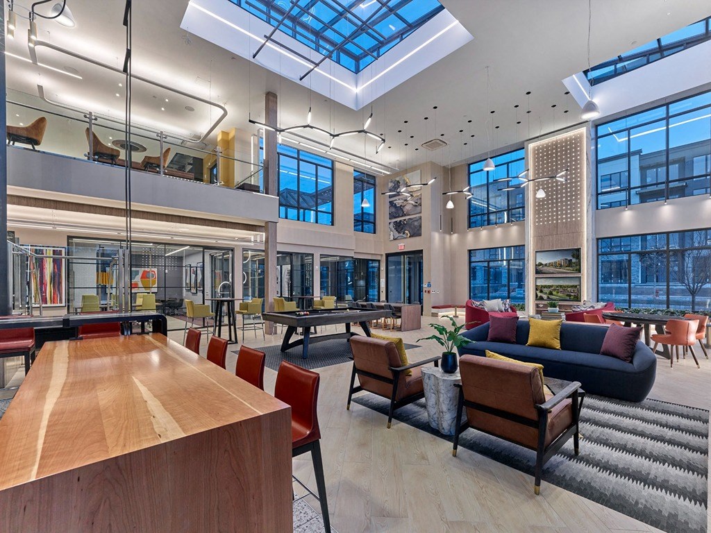 a large lobby with lots of furniture and a ping pong table