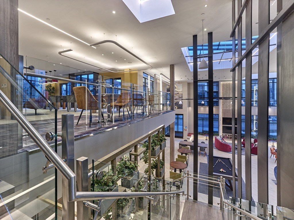 a view of the lobby of a building with glass walls