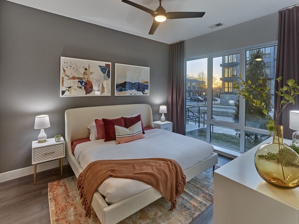 a bedroom with a large bed and a ceiling fan