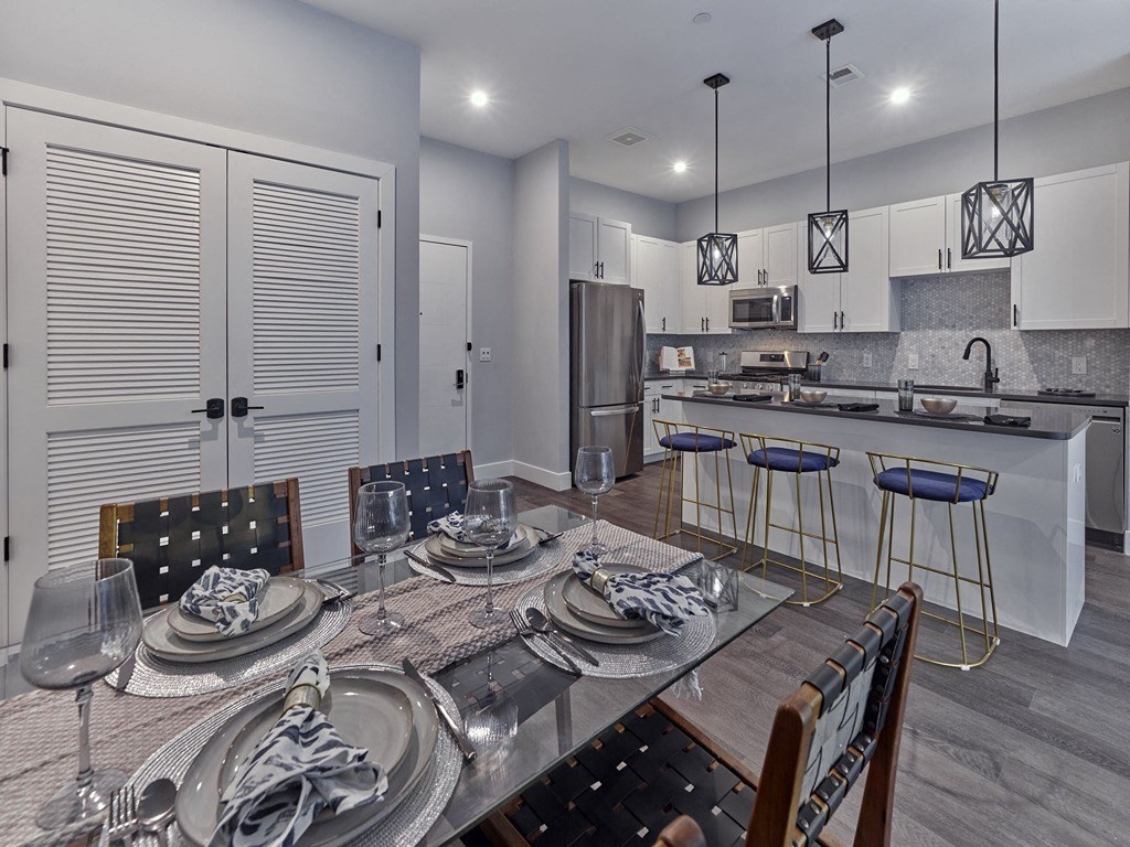 a kitchen and dining room with a table and chairs